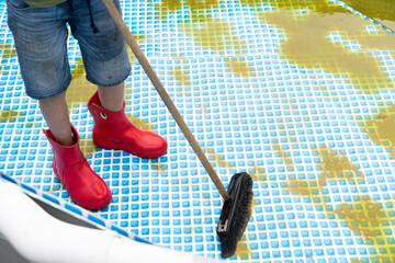 Cleaning of the frame pool, blooming green water. Outdoor pool maintenance in the summer. Sediment...