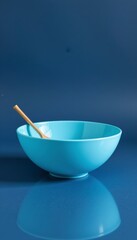 Pale Blue Ceramic Bowl with Wooden Spoon on Dark Blue Background