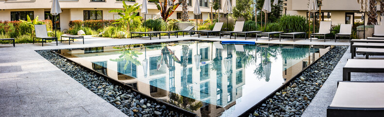 Panoramic View of Contemporary Poolside Area in Resort Complex