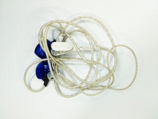 Tangled Blue Wired Earphones with White Cable and 3.5mm Jack Isolated on White Background