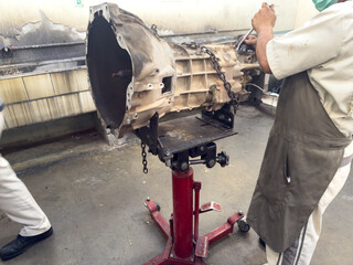 A team of expert technicians is performing maintenance on a complex car transmission system. 