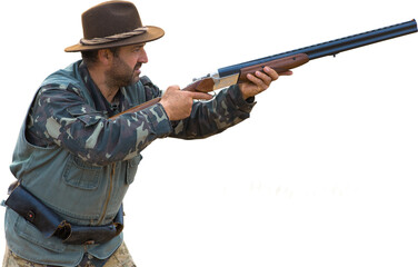 A hunter with a gun in his hands in hunting clothes in the autumn forest in search of a trophy. A man stands with weapons and hunting dogs tracking down the game.
