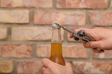Opening a cold beer bottle, returnable glass bottle