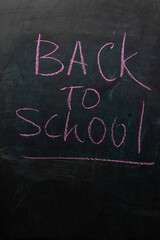 Chalk lettering on a blackboard announces back to school, capturing the excitement and anticipation...