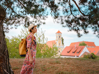Beautiful woman walking of Varazdin streets during summer day in old, historical city center. Panorama and Cityscape of famous Croatian fortress town in Europe in summer. Travel and tourism