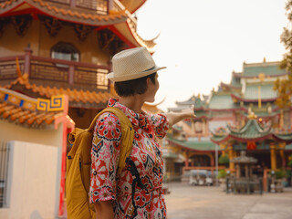 Woman Exploring Colorful Streets Near Buddhist Temples in Bangkok. Female traveler strolling through charming streets of Bangkok, surrounded by traditional architecture and beautiful Buddhist temples.
