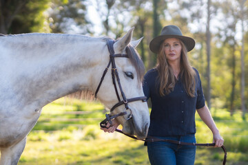 Woman possing with a whit horse