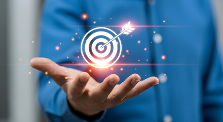Businessman holding holographic target with arrow, symbolizing goal setting and achieving success in professional environment.