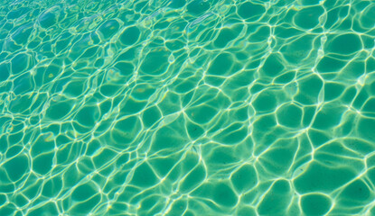 Clear Turquoise Swimming Pool Water Surface with Sunlight Reflection Patterns