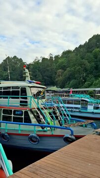 Local charter boats for inter-island crossings on Lake Toba carrying tourists, passengers and cargo. The ship travels from Parapat to the island of Samosir.