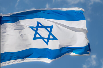 Large Israel flag waving in the wind. Israeli flag for advertising, holidays, achievements, festivals, elections. The Israeli flag flutters in the beautiful sky. Great for news.