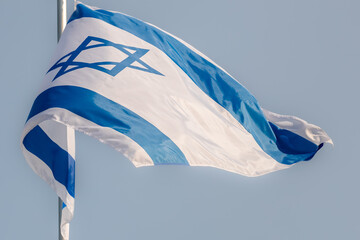 Large Israel flag waving in the wind. Israeli flag for advertising, holidays, achievements, festivals, elections. The Israeli flag flutters in the beautiful sky. Great for news.