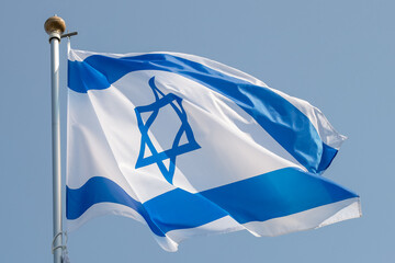 Large Israel flag waving in the wind. Israeli flag for advertising, holidays, achievements, festivals, elections. The Israeli flag flutters in the beautiful sky. Great for news.