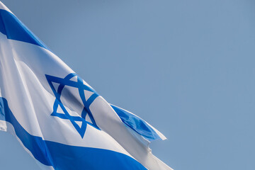 Large Israel flag waving in the wind. Israeli flag for advertising, holidays, achievements, festivals, elections. The Israeli flag flutters in the beautiful sky. Great for news.