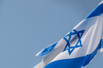 Large Israel flag waving in the wind. Israeli flag for advertising, holidays, achievements, festivals, elections. The Israeli flag flutters in the beautiful sky. Great for news.