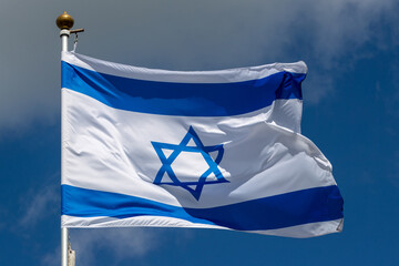 Large Israel flag waving in the wind. Israeli flag for advertising, holidays, achievements, festivals, elections. The Israeli flag flutters in the beautiful sky. Great for news.
