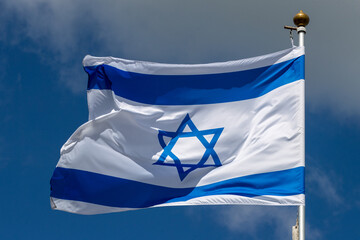 Large Israel flag waving in the wind. Israeli flag for advertising, holidays, achievements, festivals, elections. The Israeli flag flutters in the beautiful sky. Great for news.