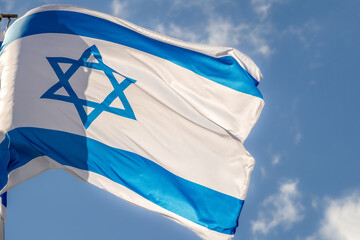 Large Israel flag waving in the wind. Israeli flag for advertising, holidays, achievements, festivals, elections. The Israeli flag flutters in the beautiful sky. Great for news.