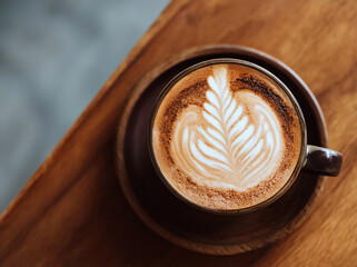 Cappuccino with Leaf Latte Art in Mug, Top View on Wooden Table