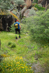 Obraz premium People trekking in Latmos mountains in spring. Latmos Caria trekking route. Latmos trekking route among historical ruins. Hiking from Latmos Mountain to Lake Bafa. Walking by Lake Bafa.