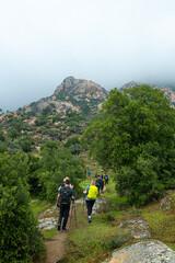 People trekking in Latmos mountains in spring.Latmos Caria trekking route. Latmos trekking route among historical ruins. Hiking from Latmos Mountain to Lake Bafa. Hiking in foggy weath.Muğla, Türkiye.