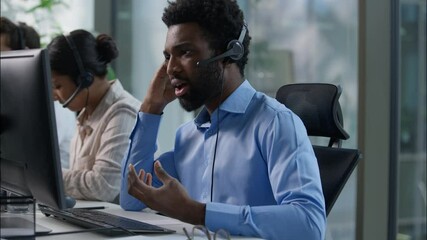 Frustrated business callcenter operators African man stressed talking helpline call center multiethnic Caucasian Indian workers headset typing computer customer service sell online sales failure upset - Powered by Adobe