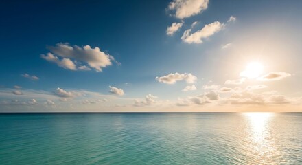 Obraz premium Serene sunset over calm turquoise ocean: peaceful tropical seascape with soft clouds