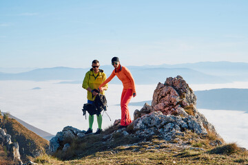 Couple in Love Enjoying the View at the Top of a Mountain.