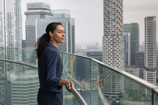 Businesswoman looking out at City View from high rise office