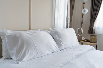 Serene and Cozy Bedroom with Soft White Linen Bedding and Natural Light Filtered Through Sheer Curtains for a Relaxing Atmosphere