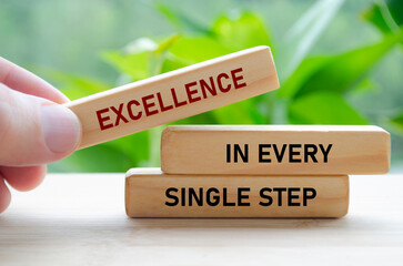 Excellence in every single step text on wooden blocks with blur nature background