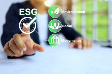 ESG environmental social governance concept with businessman pointing on checkmark to policy...