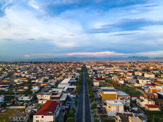 High-angle drone view of Durrës, Albania, captured during golden hour at sunset. 
