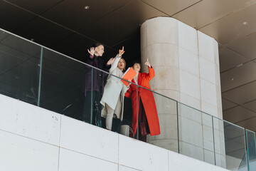 A group of women engaged in a professional discussion on a balcony, symbolizing leadership...