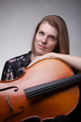 Woman leaning on a cello
