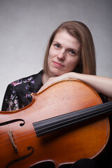 Woman with cello, resting chin on instrument.