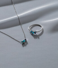 This elegant jewelry set includes a silver necklace and a ring, both beautifully designed with...
