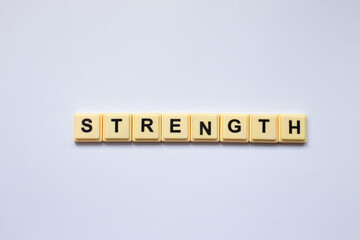 Strength word with alphabet cubes isolated on white background
