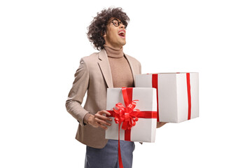 Excited young man holding a gift box and looking up