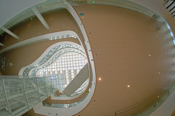 Modern building interior with curved floors, skylights and glass walls