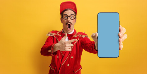 Funny man in a red suit showing a smartphone