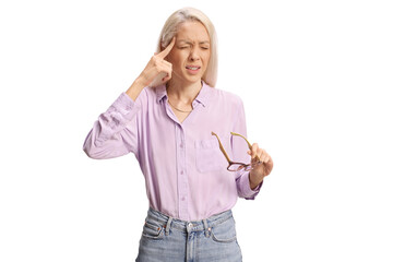 Woman holding glasses and suffering from headache