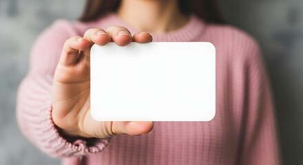 Obraz premium Woman Holding Blank White Business Card Mockup Perfect for Branding and Marketing