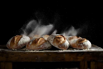 Fototapeten Fresh Artisan Sourdough Bread with Flour Splash on Rustic Wooden Table black background © YouAreBeautiful