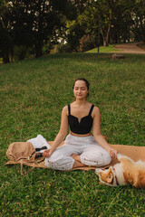 Fit sporty mindful young woman meditating, doing yoga and breathing exercises with eyes closed,...