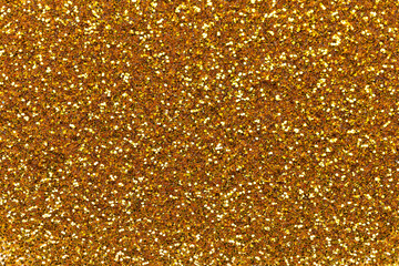 Shiny gold glitter texture background with sparkling light reflections, perfect for luxury design,...