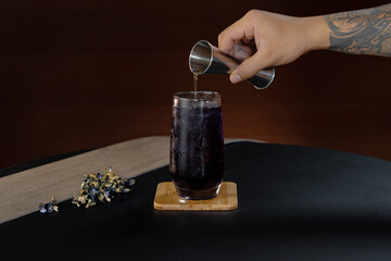 A tempting shot of fragrant jasmine tea as sugar is being poured, enhancing its floral aroma and...