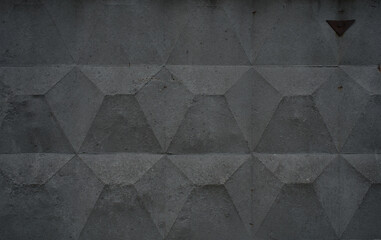 Textured gray concrete wall with geometric pattern
