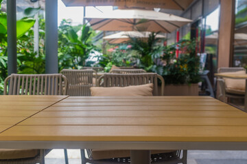empty wooden dining table and chairs in urban oasis