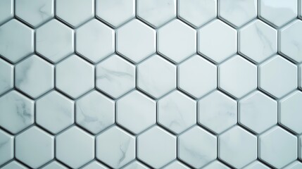Naklejka premium White hexagonal marble tiles with subtle gray veins form a sleek, modern geometric pattern on a wall or floor surface.